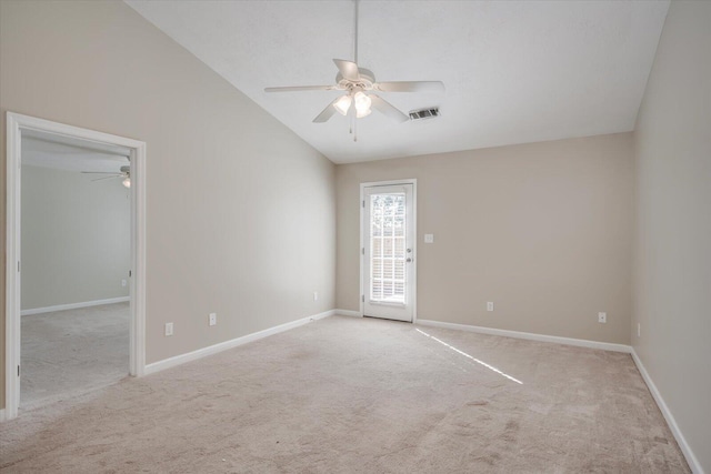 carpeted empty room with ceiling fan and vaulted ceiling