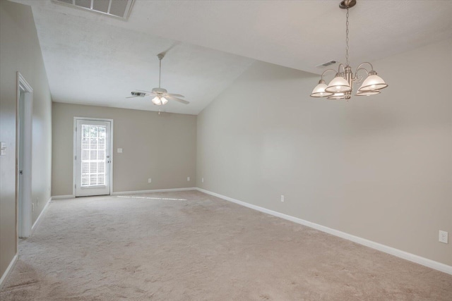 spare room with ceiling fan with notable chandelier, light colored carpet, and vaulted ceiling