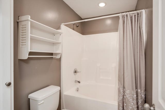 bathroom featuring toilet and shower / tub combo with curtain