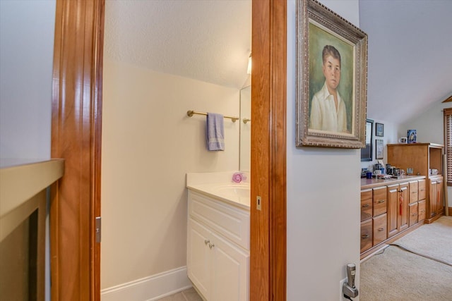 207 Rosewood Ln, Mccormick, SC 29835 - bathroom featuring vanity, vaulted ceiling, baseboards, and a textured ceiling