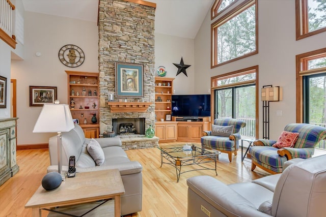 207 Rosewood Ln, Mccormick, SC 29835 - living room with high vaulted ceiling, a fireplace, and light wood-style flooring