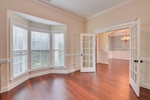 5197 Windmill Pl, Evans, GA 30809 - empty room featuring french doors, a chandelier, wood finished floors, and ornamental molding