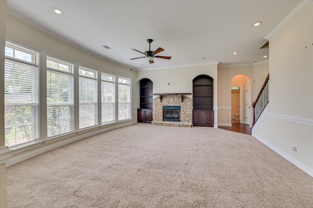 5197 Windmill Pl, Evans, GA 30809 - unfurnished living room with carpet flooring, a stone fireplace, a ceiling fan, arched walkways, and recessed lighting