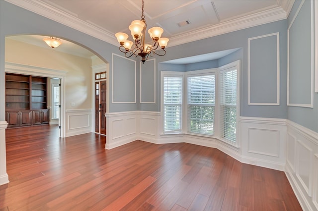 5197 Windmill Pl, Evans, GA 30809 - unfurnished dining area featuring arched walkways, a chandelier, a decorative wall, wood finished floors, and a wainscoted wall