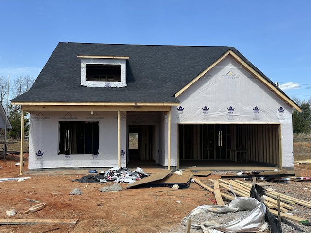 property under construction with an attached garage, a shingled roof, and stucco siding