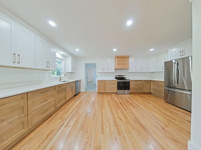 623 Stanton Dr, North Augusta, SC 29841 - kitchen with appliances with stainless steel finishes, light wood-style floors, light countertops, recessed lighting, and white cabinetry