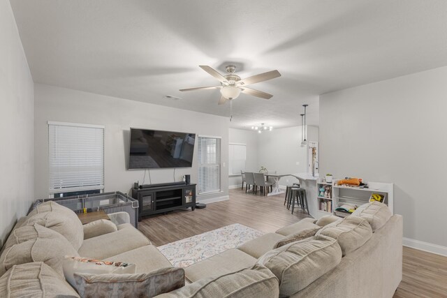 living room featuring ceiling fan and light wood-type flooring