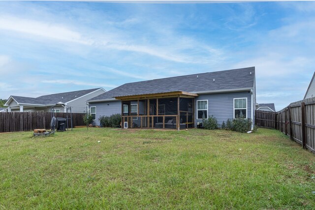 back of house featuring a sunroom and a yard