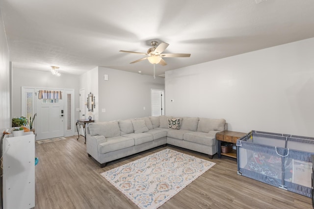 living room with ceiling fan and hardwood / wood-style flooring