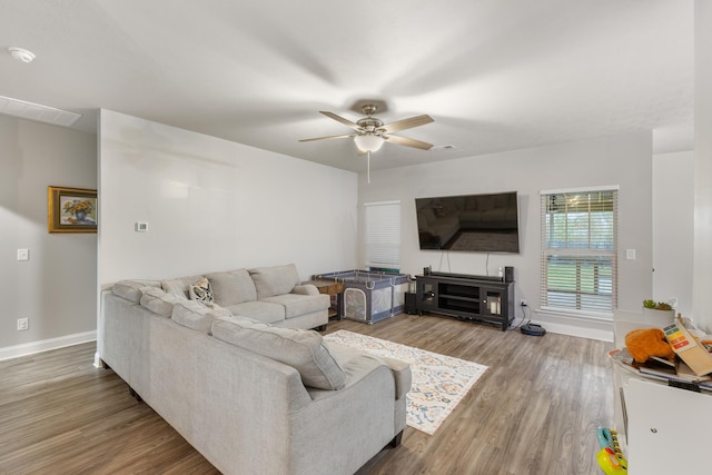 living room featuring wood-type flooring and ceiling fan