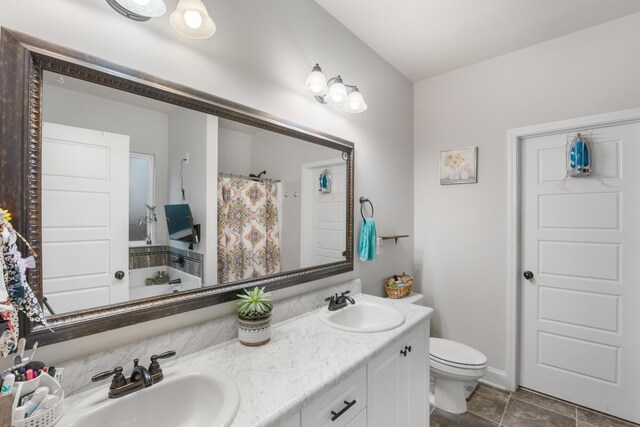 bathroom featuring tile patterned floors, vanity, toilet, and walk in shower