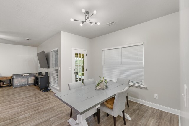 dining room featuring light hardwood / wood-style floors and a notable chandelier