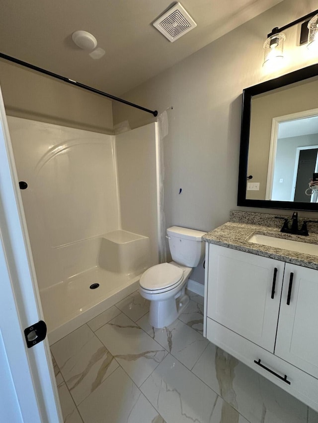 bathroom featuring vanity, toilet, and walk in shower