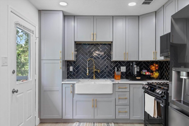 2726 Cardigan Ct, Hephzibah, GA 30815 - kitchen with gray cabinets, black appliances, a sink, light countertops, and recessed lighting