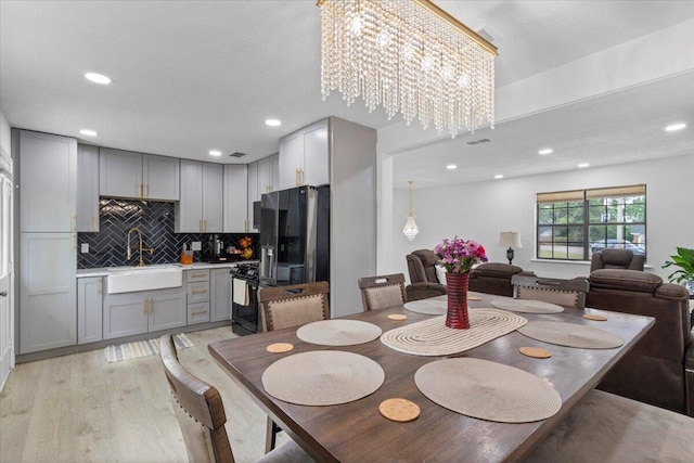 2726 Cardigan Ct, Hephzibah, GA 30815 - dining room featuring light wood finished floors, recessed lighting, and a chandelier