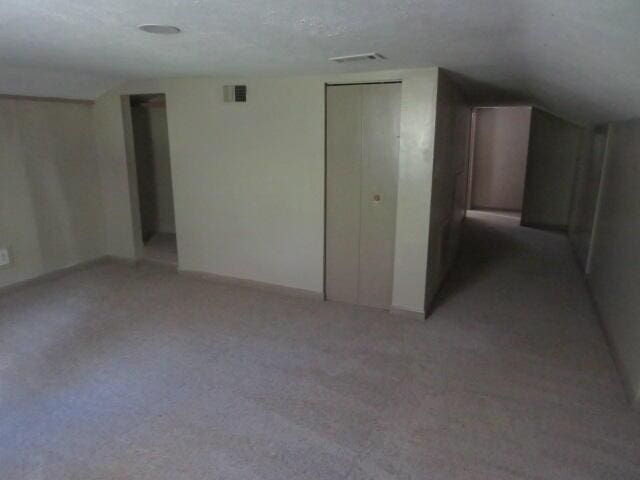 basement featuring a textured ceiling