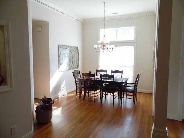 dining area featuring dark hardwood / wood-style floors and a chandelier