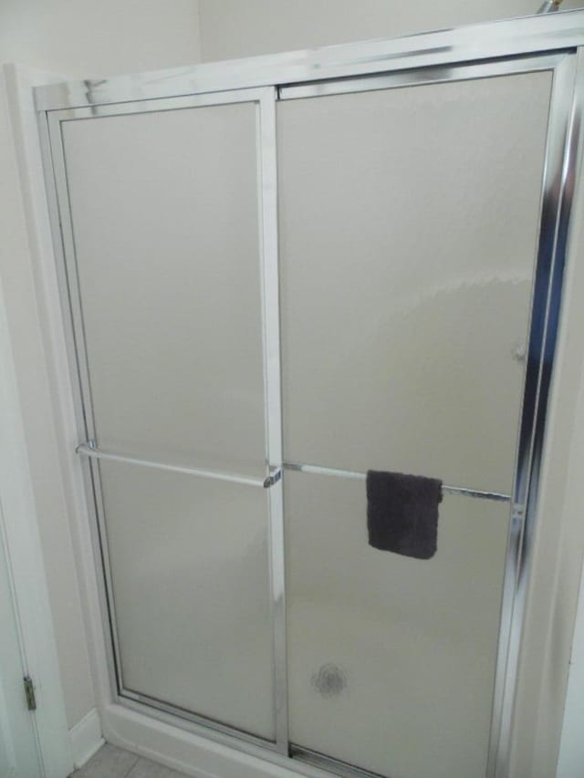 bathroom with a shower with door