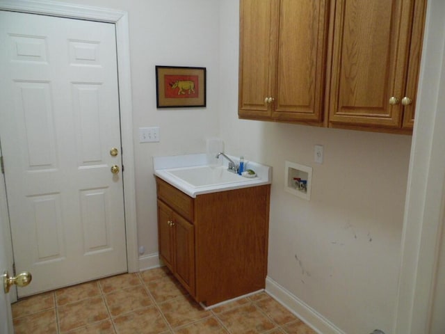 laundry room featuring cabinets, sink, washer hookup, and light tile patterned floors