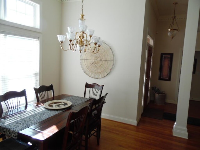 dining area with an inviting chandelier and dark hardwood / wood-style flooring