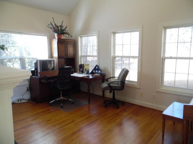 office space with light wood-style flooring, lofted ceiling, and baseboards