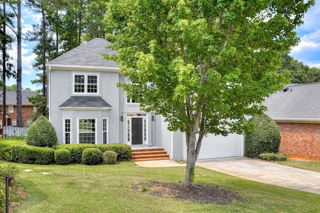 view of front of property with a front lawn and a garage