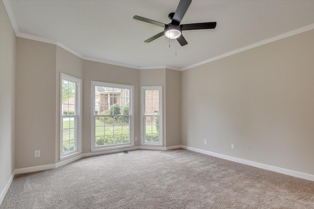 carpeted spare room with crown molding, ceiling fan, and a healthy amount of sunlight