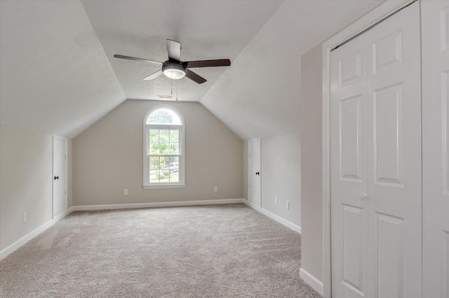 bonus room with ceiling fan, light colored carpet, and lofted ceiling