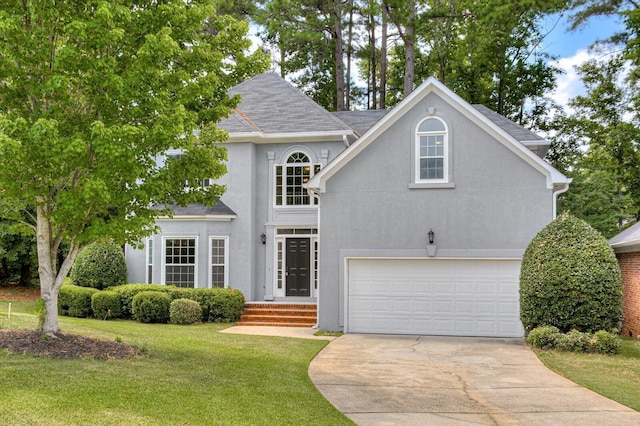 view of front of home with a garage and a front yard