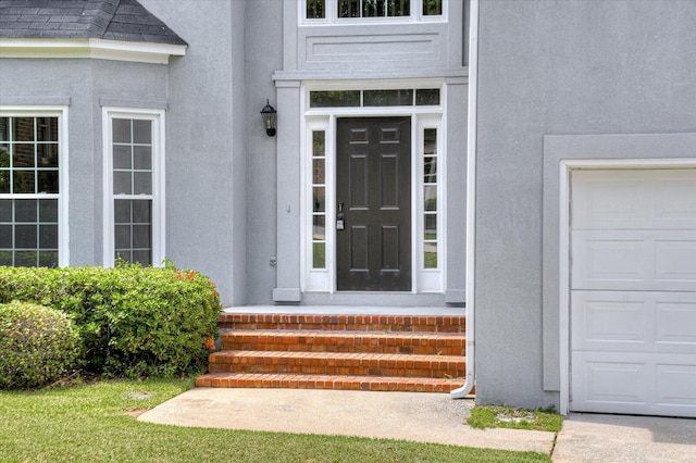 doorway to property with a garage