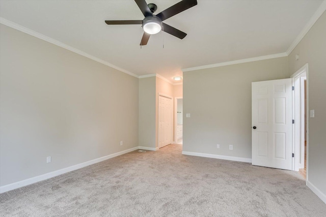 carpeted spare room featuring ceiling fan and crown molding