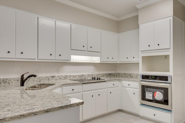 kitchen featuring white cabinetry, sink, and oven