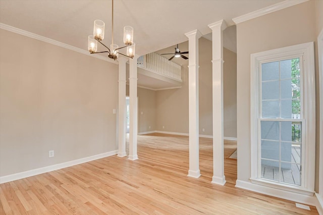 unfurnished dining area with ceiling fan with notable chandelier, light wood-type flooring, and crown molding