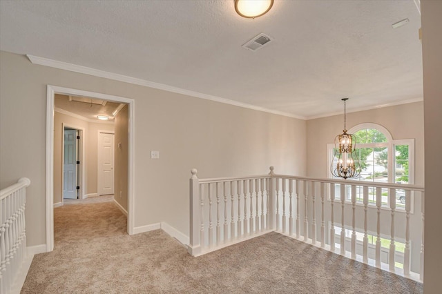 hallway with a textured ceiling, light carpet, a notable chandelier, and ornamental molding