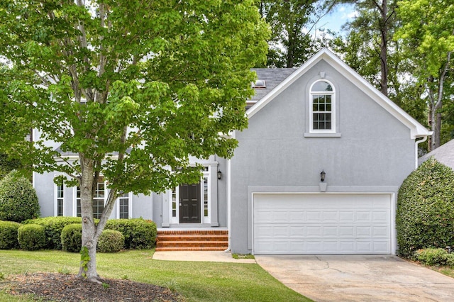 view of front facade featuring a garage and a front yard