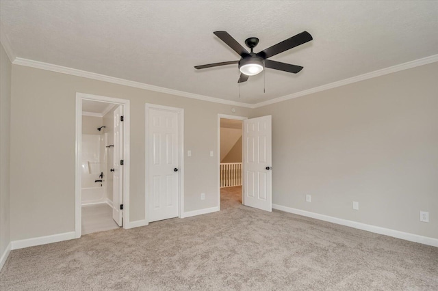 unfurnished bedroom with ceiling fan, crown molding, connected bathroom, and light carpet