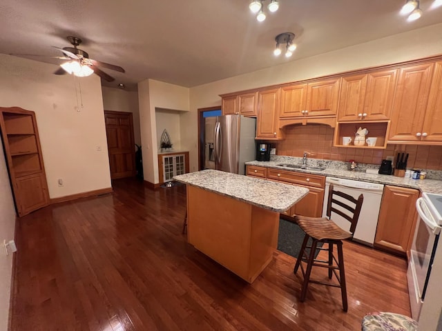 139 Cresent Dr, Mccormick, SC 29835 - kitchen featuring white appliances, a center island, tasteful backsplash, a ceiling fan, and dark wood-style floors