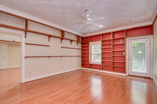 12 Shadowbrook Cir, Augusta, GA 30909 - unfurnished room featuring crown molding, light wood-style floors, built in shelves, baseboards, and ceiling fan