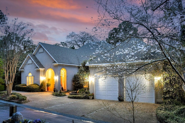 12 Shadowbrook Cir, Augusta, GA 30909 - view of front facade featuring driveway, stucco siding, a shingled roof, and an attached garage