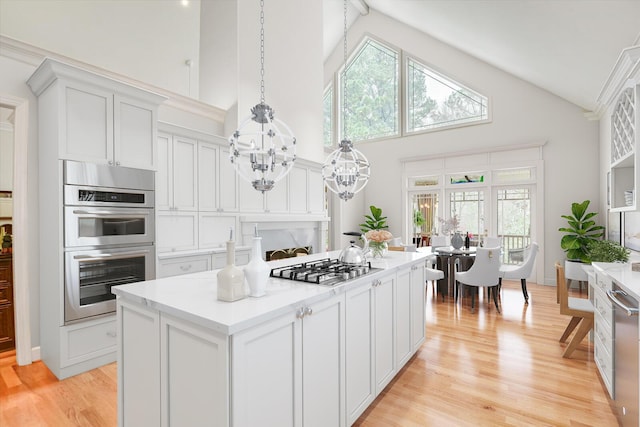 12 Shadowbrook Cir, Augusta, GA 30909 - kitchen featuring high vaulted ceiling, a chandelier, stainless steel appliances, a center island, and light countertops