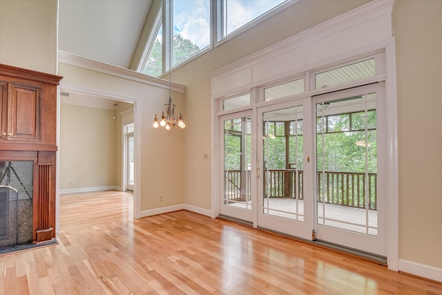 12 Shadowbrook Cir, Augusta, GA 30909 - entryway with a chandelier, a fireplace, light wood-type flooring, baseboards, and a high ceiling