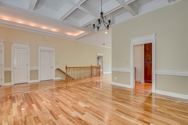 12 Shadowbrook Cir, Augusta, GA 30909 - unfurnished room with beam ceiling, light wood-style floors, a chandelier, coffered ceiling, and baseboards