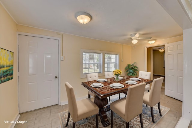 dining area with a ceiling fan, baseboards, and light tile patterned floors