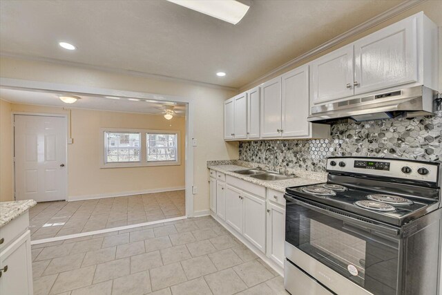 kitchen with white cabinets, under cabinet range hood, backsplash, a sink, and stainless steel electric stove