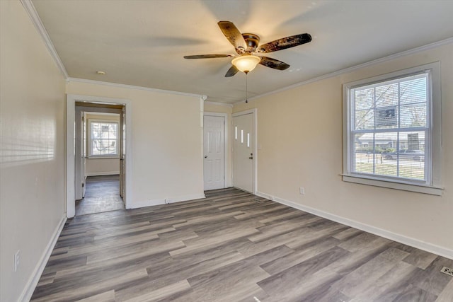 empty room featuring baseboards, wood finished floors, and ceiling fan