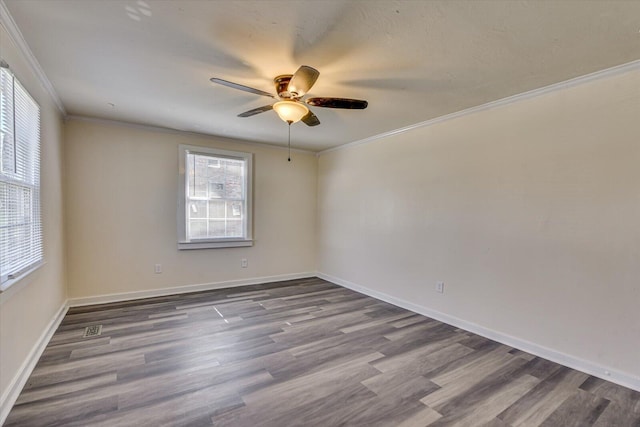 spare room featuring ceiling fan, dark wood-style flooring, and ornamental molding