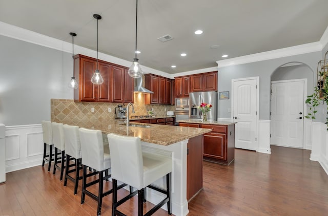 343 Abby Cir, Greenville, SC 29607 - kitchen with appliances with stainless steel finishes, wall chimney exhaust hood, a peninsula, ornamental molding, and dark wood-style flooring