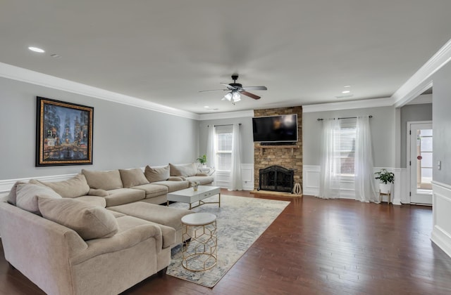 343 Abby Cir, Greenville, SC 29607 - living room with ceiling fan, crown molding, dark wood finished floors, a wainscoted wall, and a stone fireplace