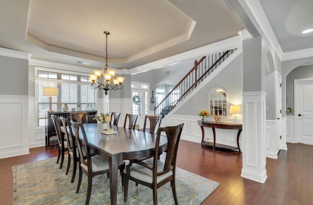 343 Abby Cir, Greenville, SC 29607 - dining area featuring a raised ceiling, a decorative wall, wood-type flooring, stairs, and a chandelier