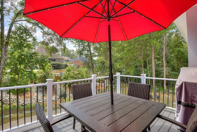 wooden terrace with outdoor dining area
